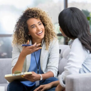 A young healthcare working speaking with another woman about her age