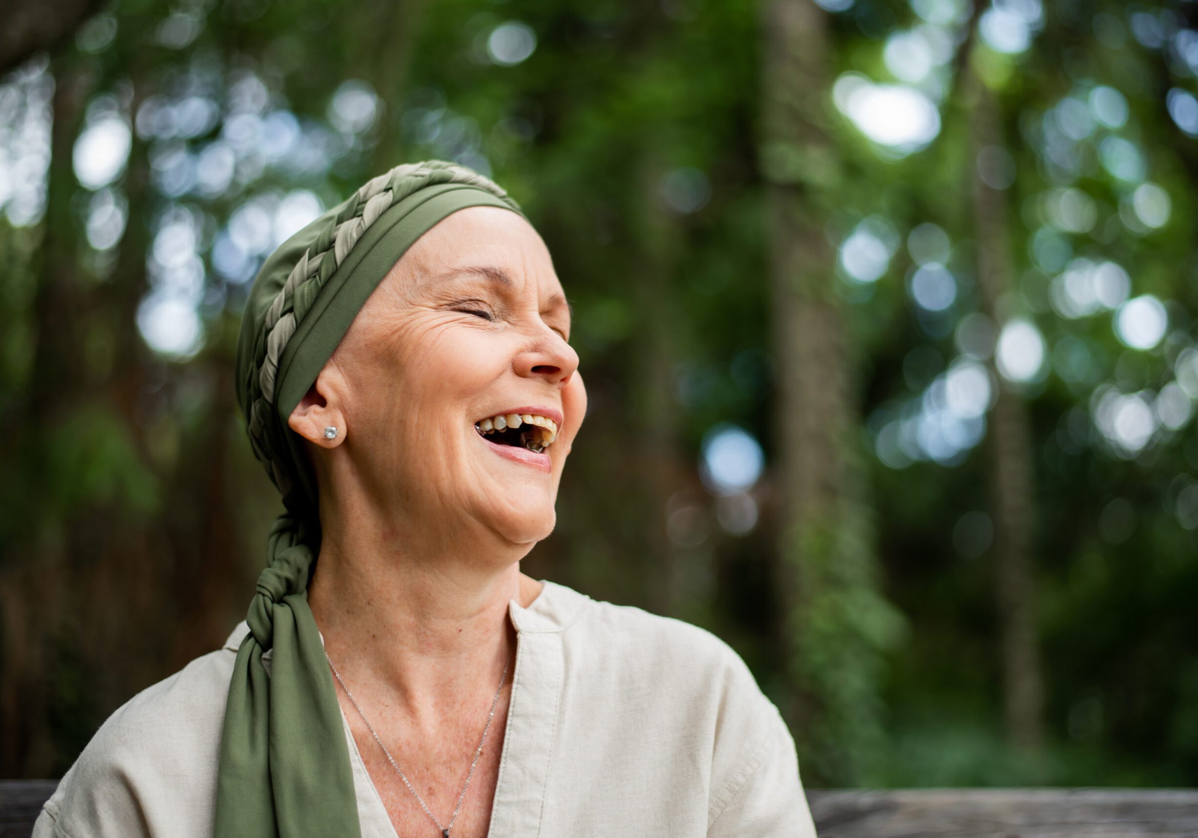 A laughing woman sitting outside